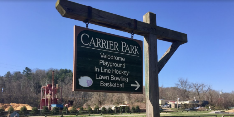 Carrier park sign with park in the background