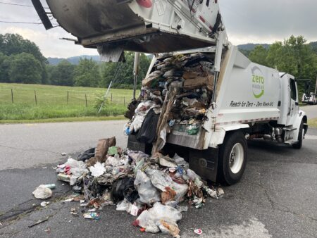 garbage truck dumping garbage on ground to eqtinguish fire