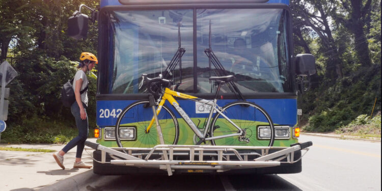 rider entering bus with bike loaded on ART transit bus bike rack