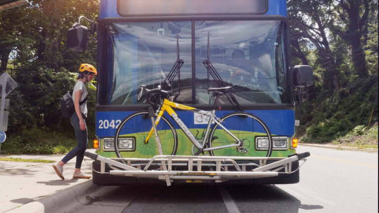 rider entering bus with bike loaded on ART transit bus bike rack