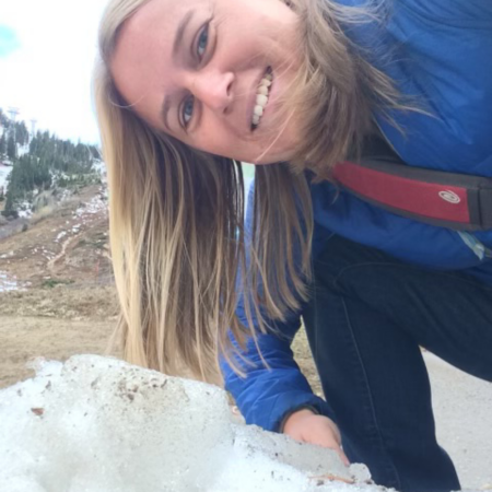 christine elyseev looking over rock