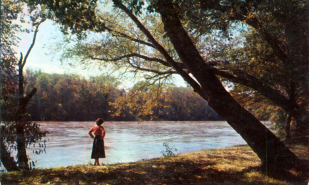 1950s image of lady standing by French Broad River