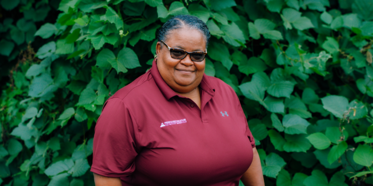 LaTonya McDowell wearing dark red Asheville Parks & Recreation polo shirt