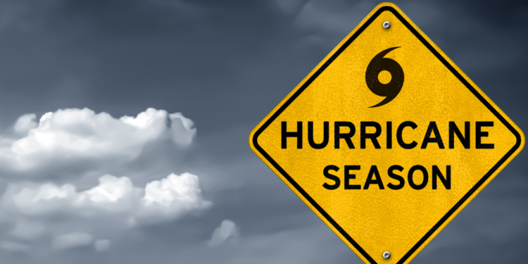 yellow hurricane season sign with dark clouds