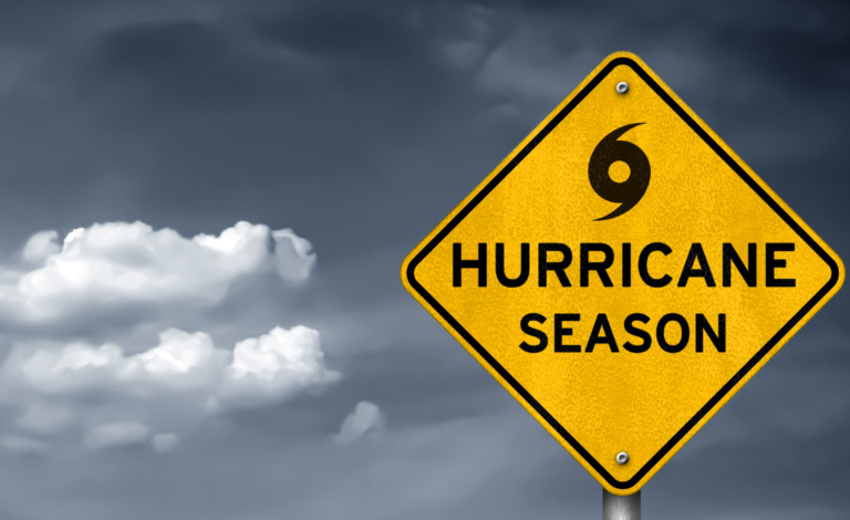 yellow hurricane season sign with dark clouds