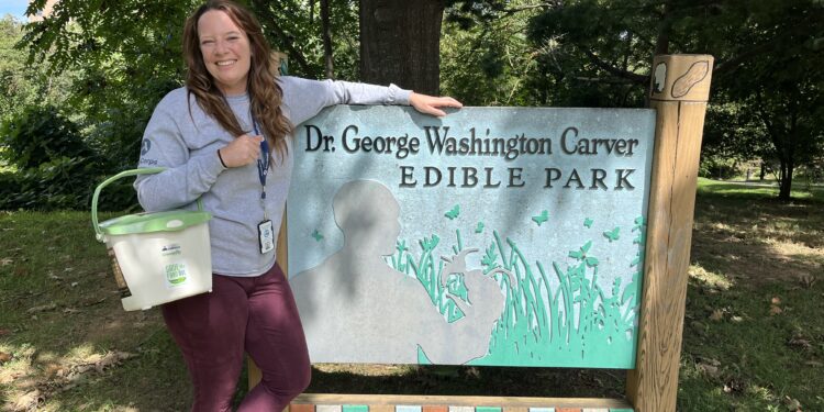 Aurora Wynne stands are George Washington Carver Edible Park sign