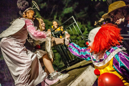 spooky clown high five with two girls in costume