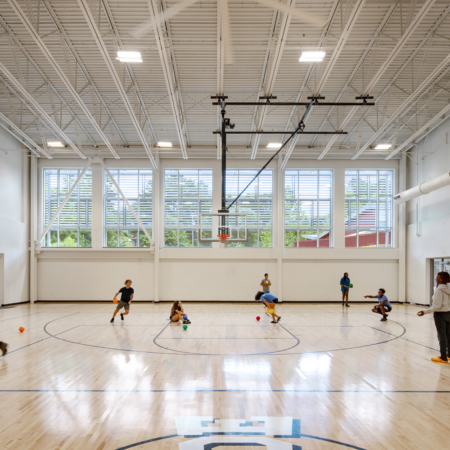 gym with kids playing basketball