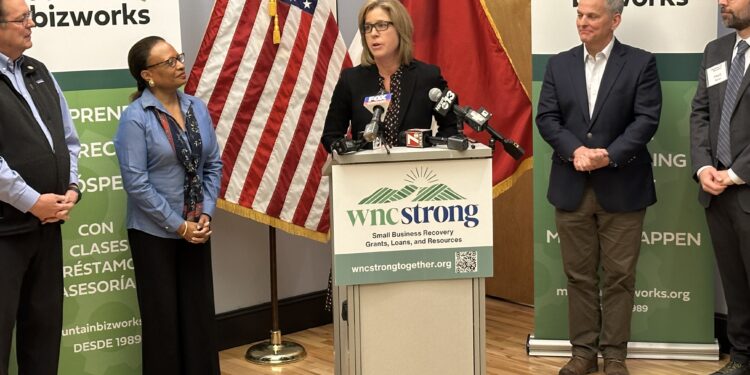 Secreatry Todman on the left of Mayor Manheimer. Governor Stein stands to the right of podium